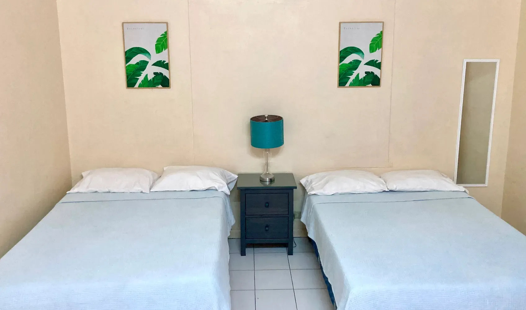 Room 1 at The Irie Inn: Beds and tropical decor